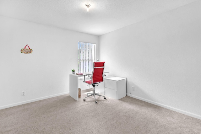 office with light colored carpet, a textured ceiling, and baseboards