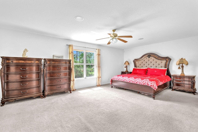 bedroom featuring baseboards, a ceiling fan, and light colored carpet