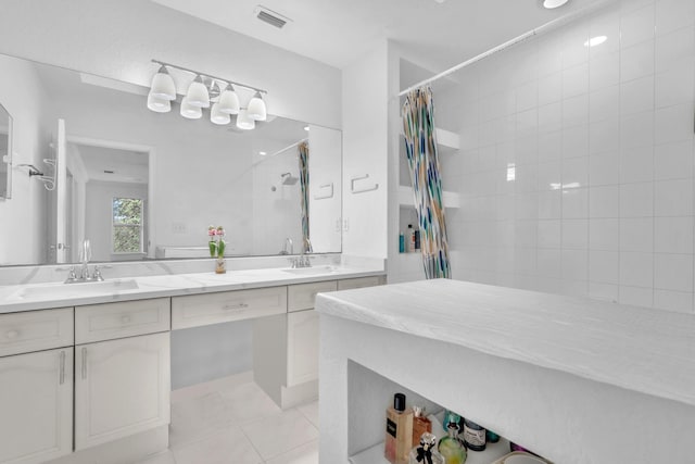 bathroom with tile patterned flooring, visible vents, a sink, and tiled shower