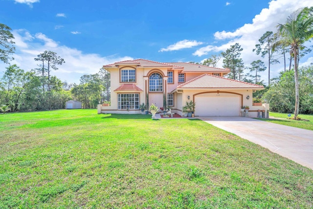 mediterranean / spanish house featuring a garage, concrete driveway, a tile roof, a front yard, and stucco siding