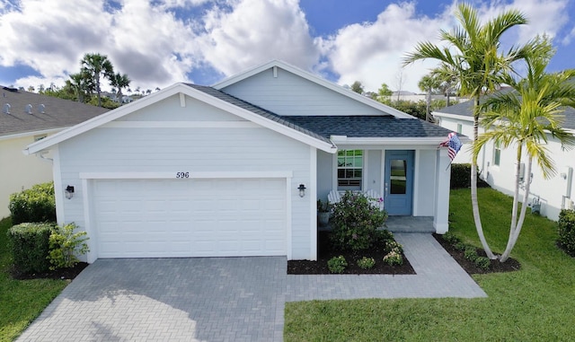 view of front of house with a garage and a front lawn