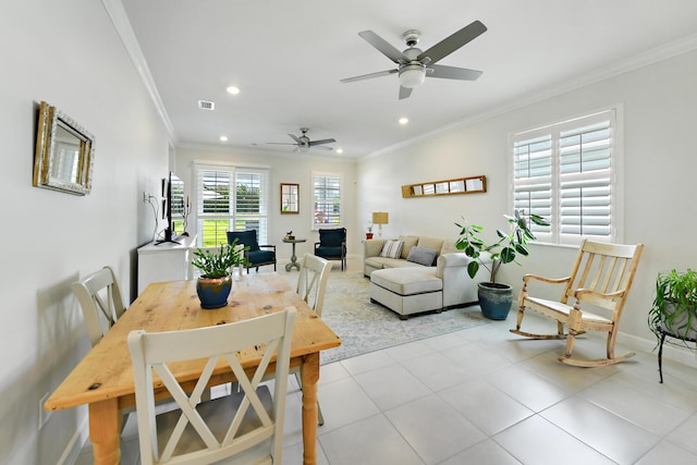 tiled dining area with crown molding, plenty of natural light, and ceiling fan