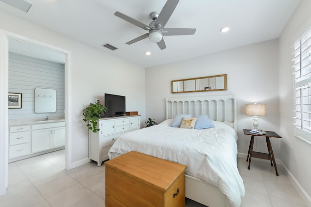 bedroom featuring multiple windows, sink, ensuite bath, and ceiling fan