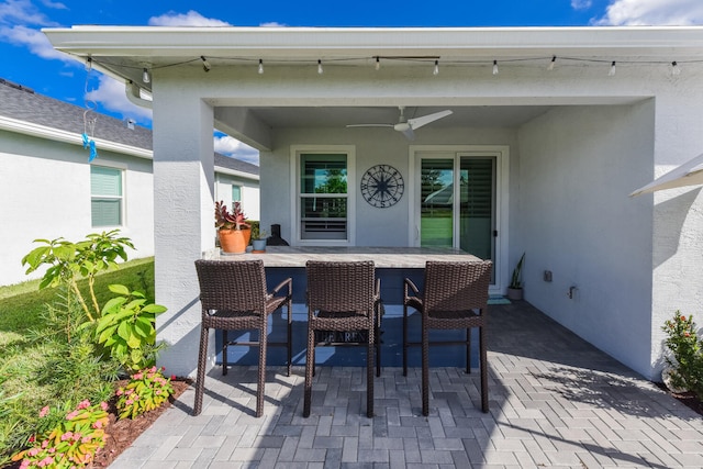 view of patio with a bar and ceiling fan