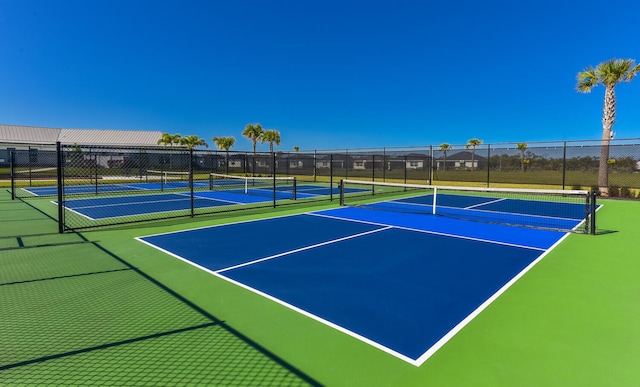 view of tennis court featuring basketball hoop