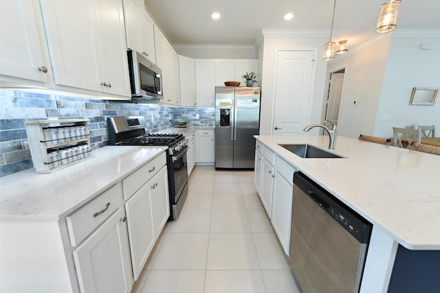 kitchen with pendant lighting, stainless steel appliances, sink, and white cabinets