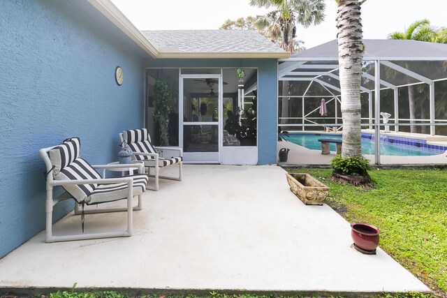 view of swimming pool featuring a lanai and a patio area