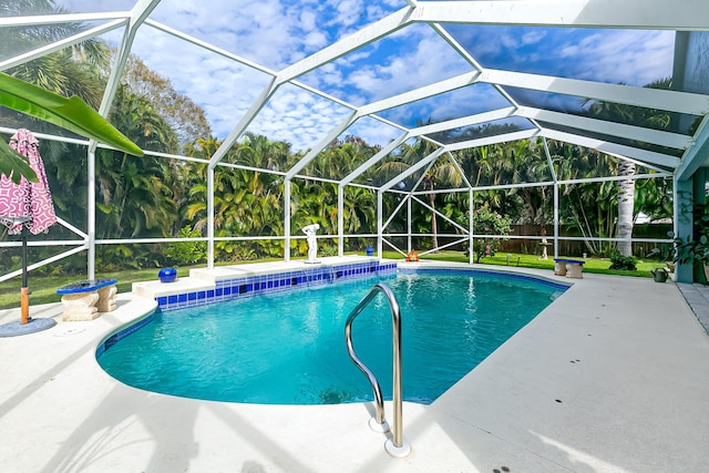 view of swimming pool featuring a lanai and a patio area