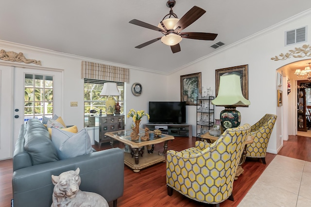 living room with vaulted ceiling, ornamental molding, hardwood / wood-style floors, and ceiling fan