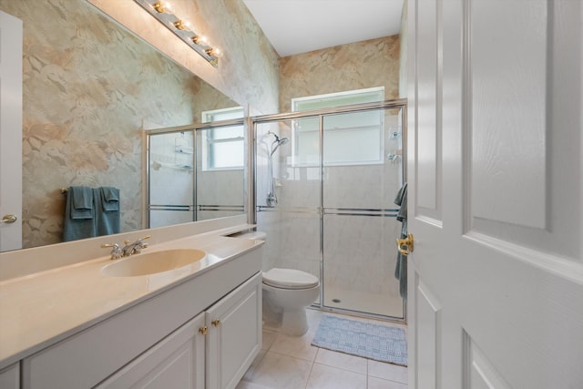 bathroom with tile patterned floors, toilet, a shower with shower door, and vanity