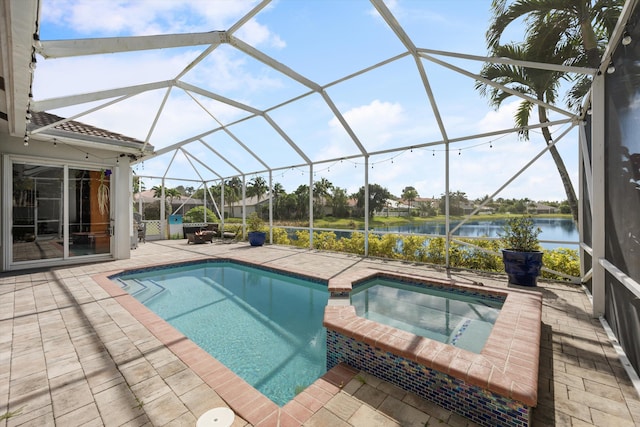 view of pool featuring a lanai, a patio area, a water view, and an in ground hot tub