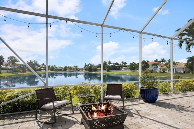 sunroom / solarium featuring a water view