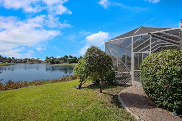 view of yard with a water view and a lanai