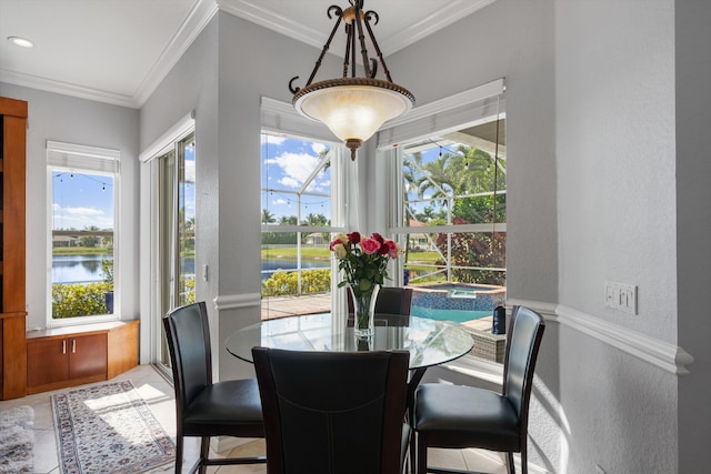 dining room with crown molding, a water view, and tile patterned floors