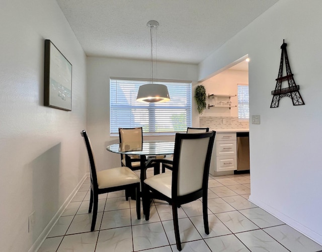 dining space featuring a textured ceiling