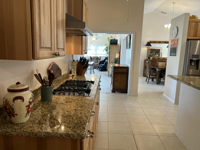 kitchen with light stone counters, sink, light tile patterned flooring, and appliances with stainless steel finishes