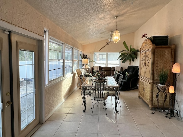 tiled dining area featuring lofted ceiling and a textured ceiling