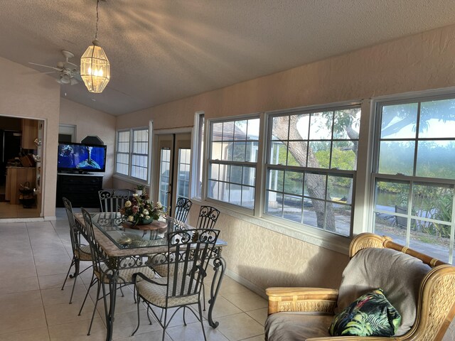 tiled living room with lofted ceiling and a textured ceiling