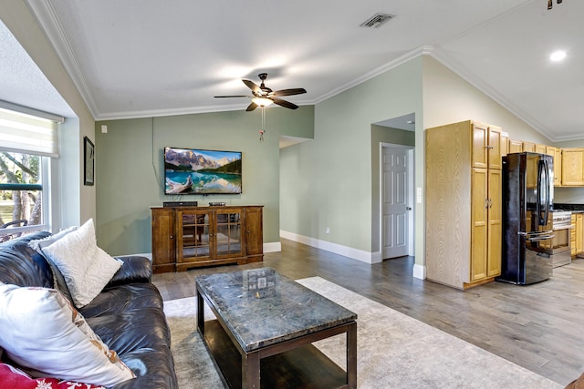 living room with crown molding, lofted ceiling, hardwood / wood-style floors, and ceiling fan