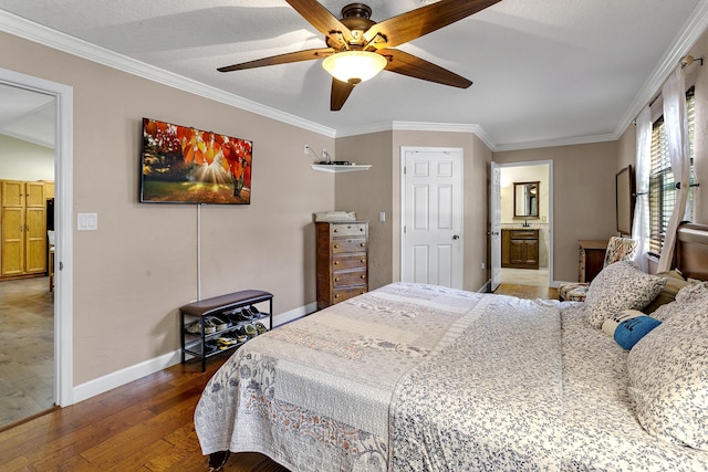 bedroom featuring dark wood-type flooring, ceiling fan, ornamental molding, and ensuite bath