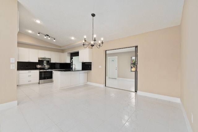 kitchen featuring vaulted ceiling, decorative light fixtures, white cabinetry, sink, and electric range