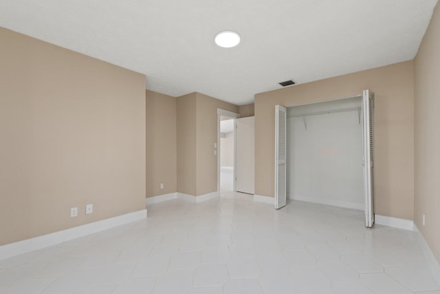 unfurnished bedroom featuring a closet and light tile patterned floors