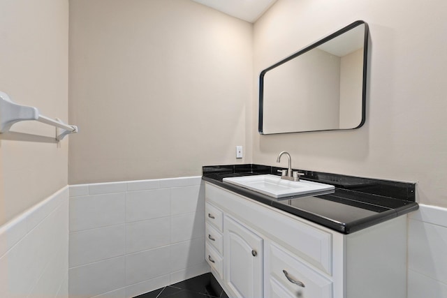 bathroom featuring tile patterned flooring, vanity, and tile walls