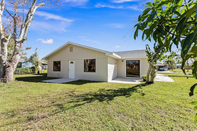 back of house featuring a yard and a patio area