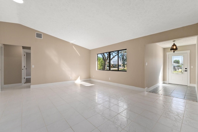 tiled spare room featuring vaulted ceiling and a wealth of natural light