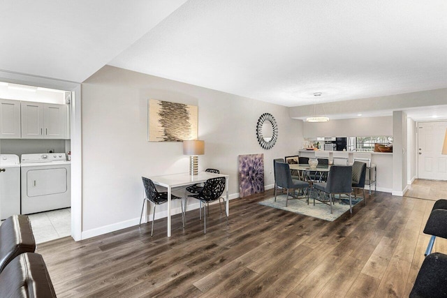 dining space featuring hardwood / wood-style flooring and washing machine and dryer