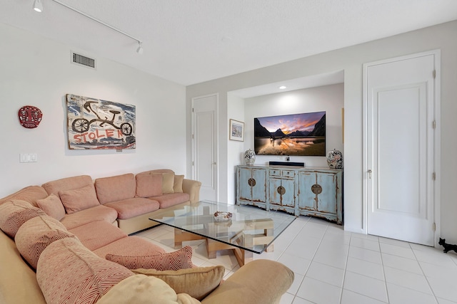 tiled living room featuring track lighting