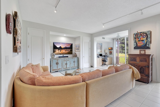 living room with light tile patterned flooring and track lighting