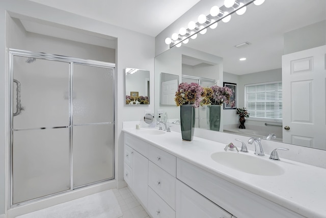 bathroom featuring tile patterned flooring, vanity, and an enclosed shower