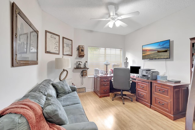 home office featuring ceiling fan, a textured ceiling, and light hardwood / wood-style floors