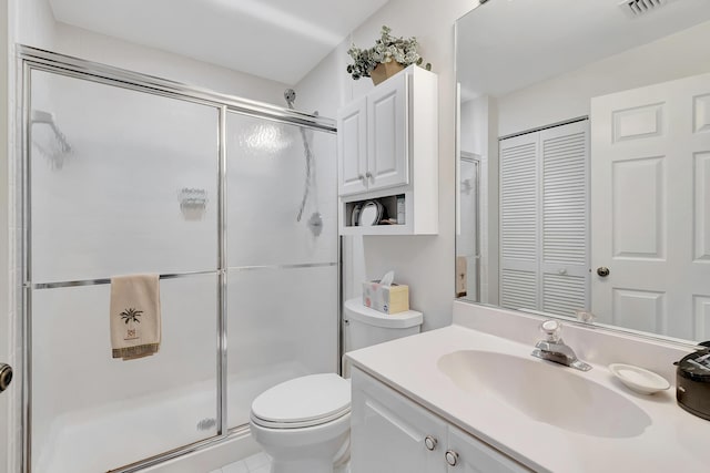 bathroom with walk in shower, vanity, and toilet