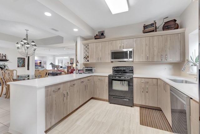 kitchen featuring sink, light brown cabinets, kitchen peninsula, and appliances with stainless steel finishes