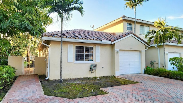 mediterranean / spanish-style house with a garage