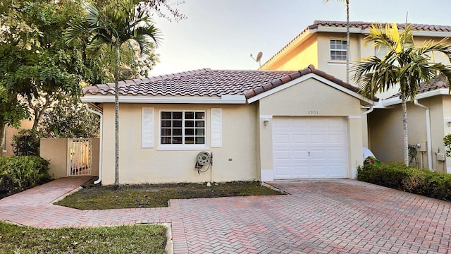 mediterranean / spanish-style home featuring a garage