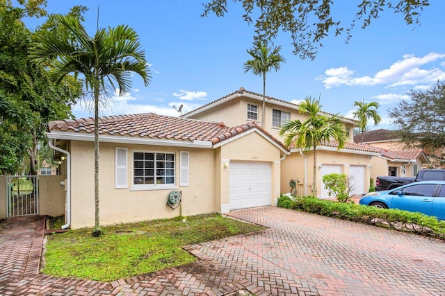 mediterranean / spanish home with a garage