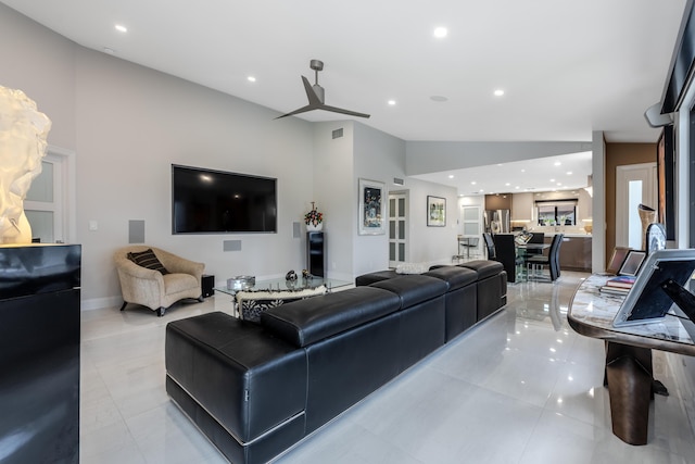 living room featuring vaulted ceiling and light tile patterned floors