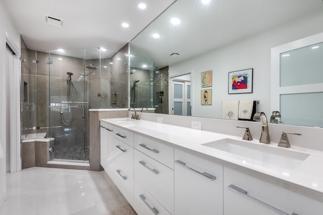 bathroom with vanity and a shower with shower door