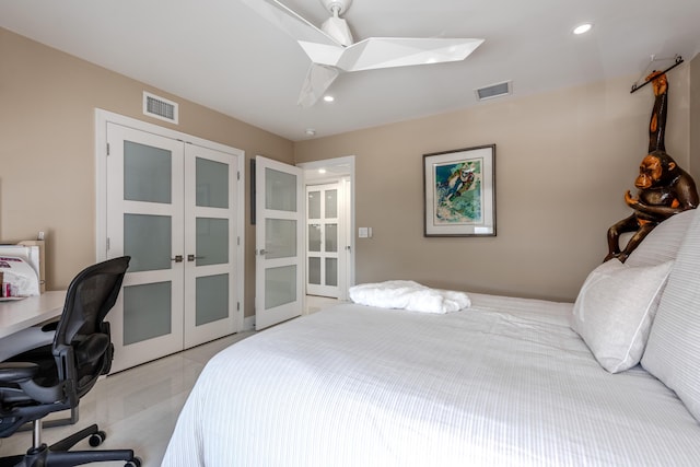 bedroom with a closet, light tile patterned floors, and french doors