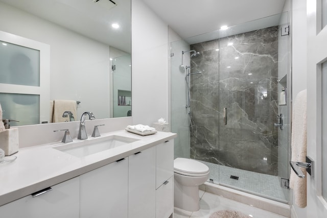 bathroom featuring vanity, an enclosed shower, and toilet