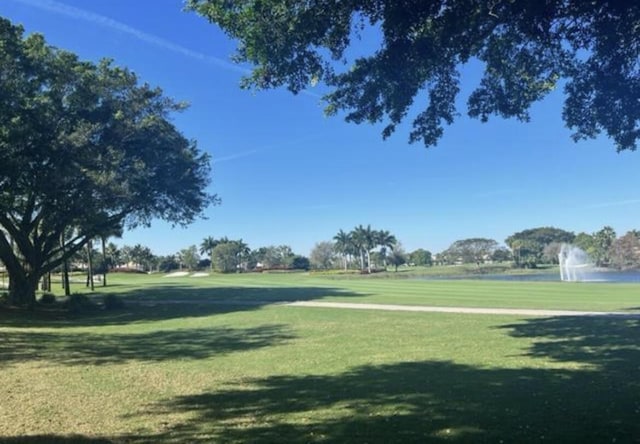 view of community with a yard and a water view