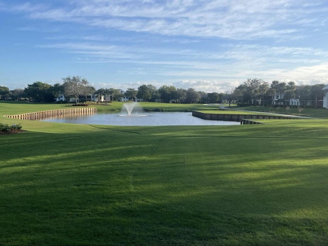 view of community featuring a water view and a lawn