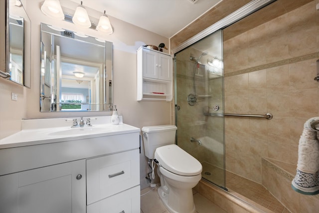 bathroom with toilet, vanity, tile patterned floors, and walk in shower