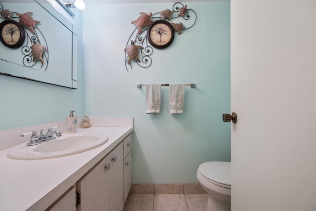 bathroom featuring vanity, tile patterned floors, and toilet