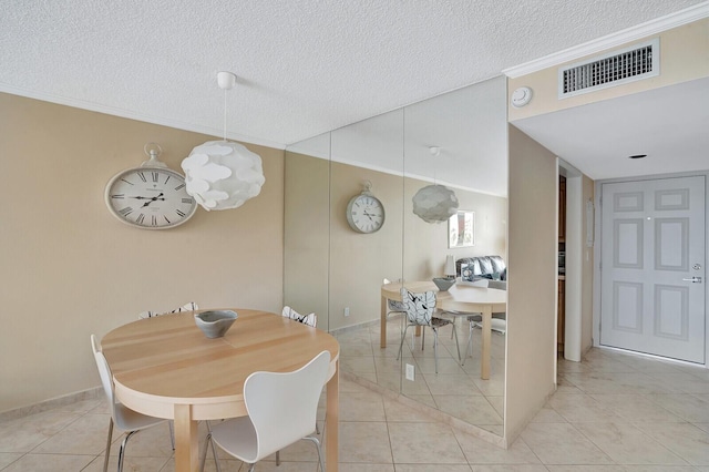 dining space with ornamental molding, a textured ceiling, and light tile patterned flooring