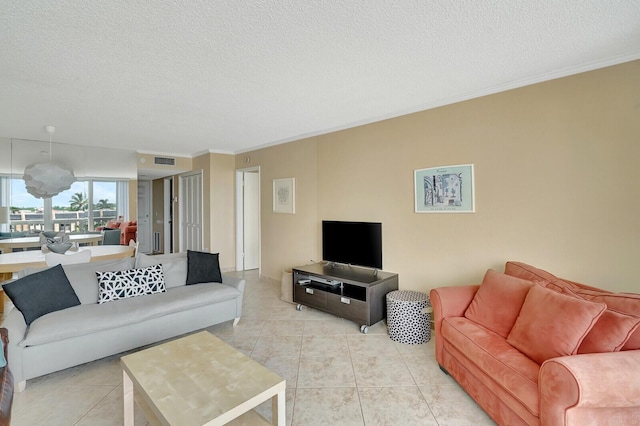 tiled living room featuring crown molding and a textured ceiling