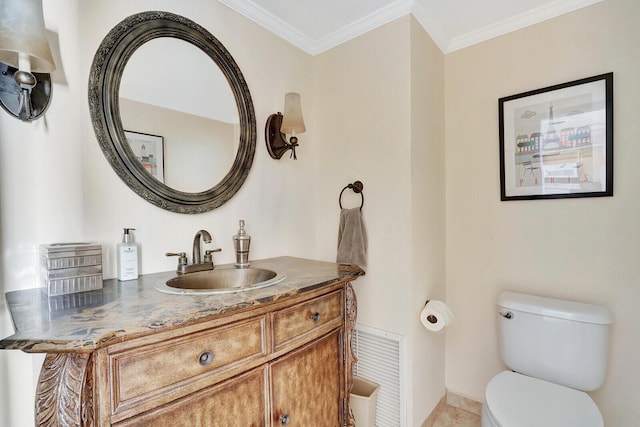 bathroom featuring vanity, ornamental molding, and toilet